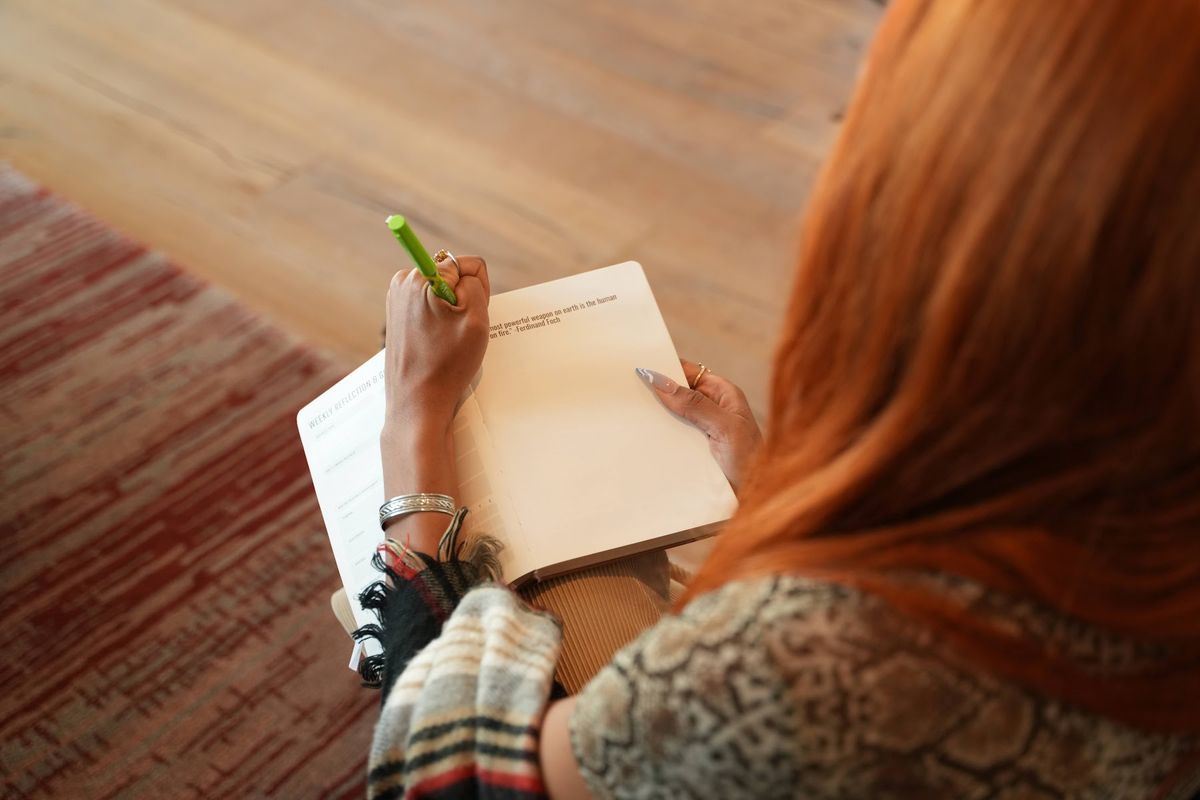 A participant writing in a VTB workshop worksheet